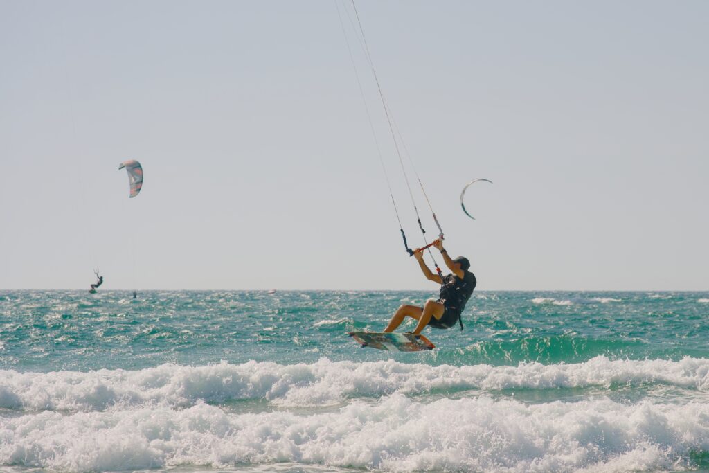 Surfing competitors at the Tel Aviv Surfing Cup perform tricks on the waves.